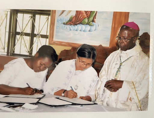 Sister Semerita (far right) signing her final vows at St Jude Kyarusonzi parish in western Uganda